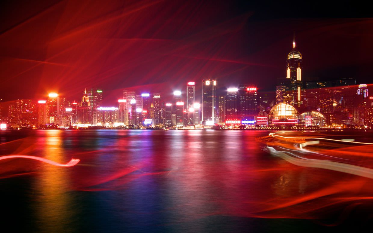 A long exposure of Hong Kong as an old red-sailed galleon passes close by