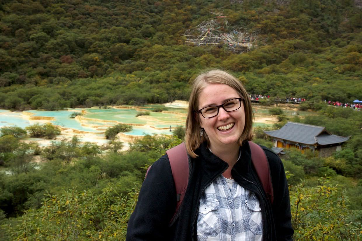 Samantha and the multi-coloured pond at the top of Huanglong park