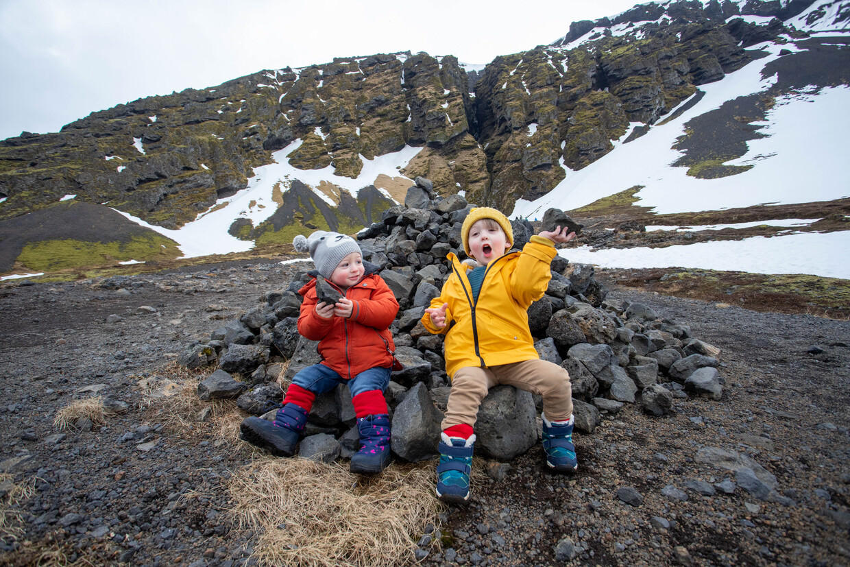 The boys enjoying piles of rocks