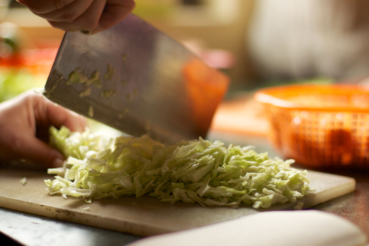 Slicing the cabbage in preparation for the filler