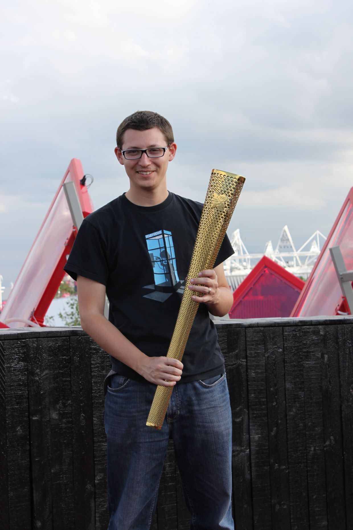 Paul holding the olympic torch