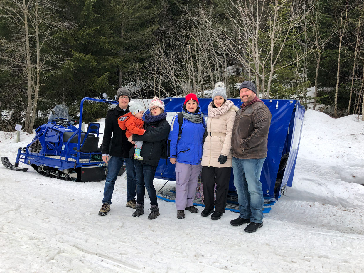The family, preparing to board a snowmobile